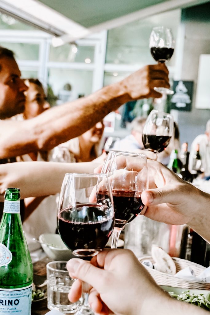 reunión comida en una mesa brindando con vino
